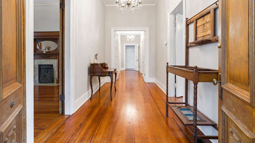 Polished hardwood flooring in a long interior corridor