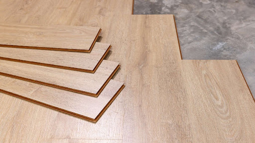 Stacked laminate flooring planks showing wood grain texture