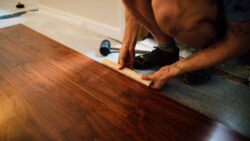 Installing hardwood flooring planks with proper alignment and spacing.
