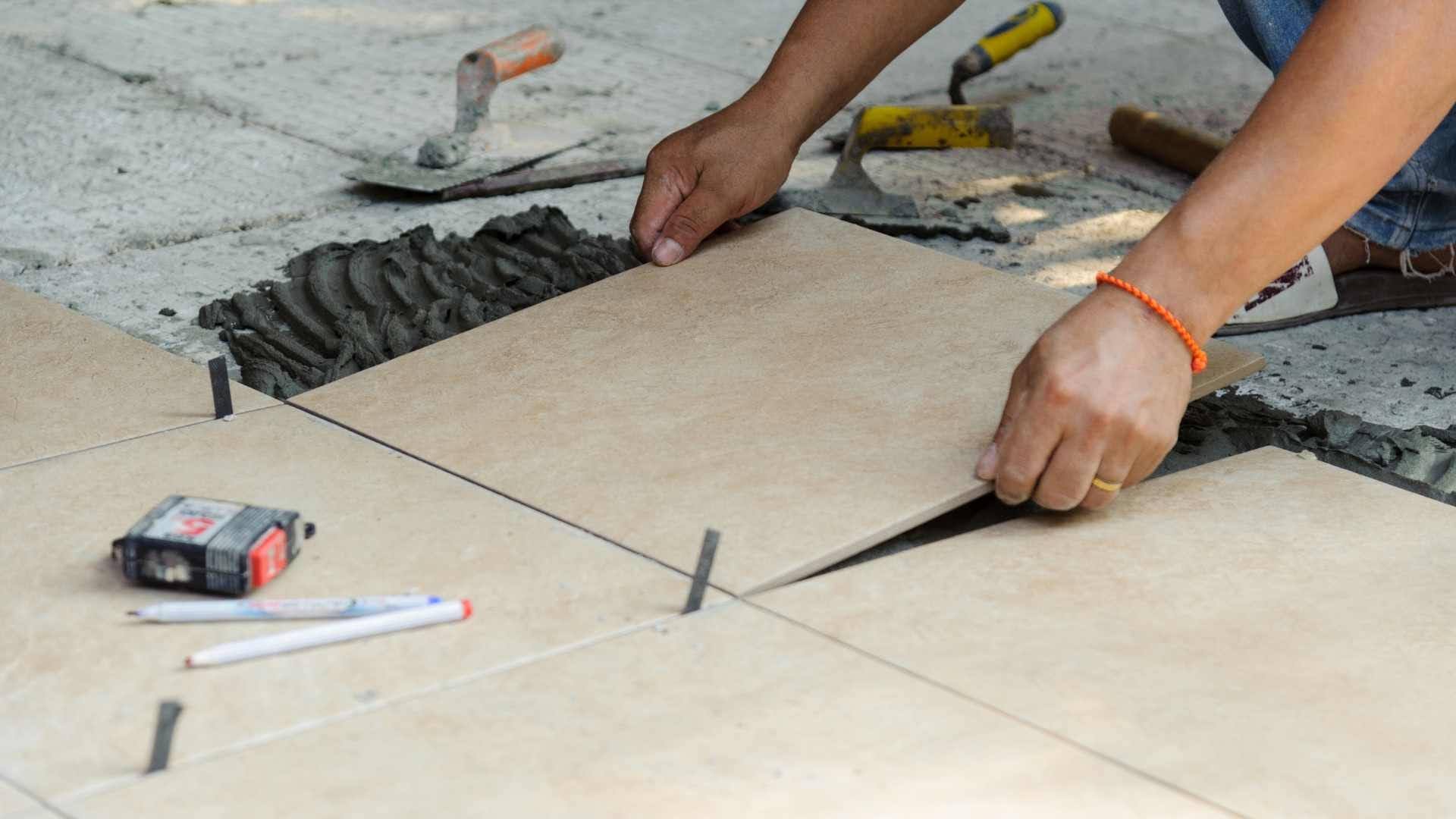 Installing floor tiles with precise spacing and alignment.