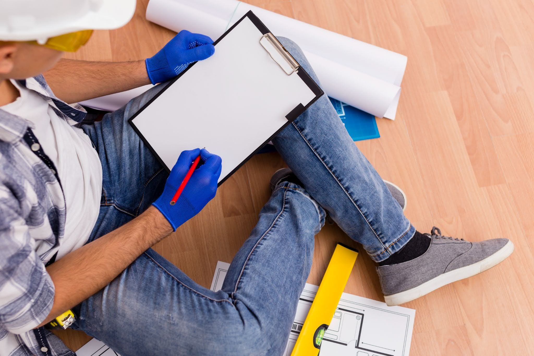 Floor inspector completing a flooring inspection checklist.